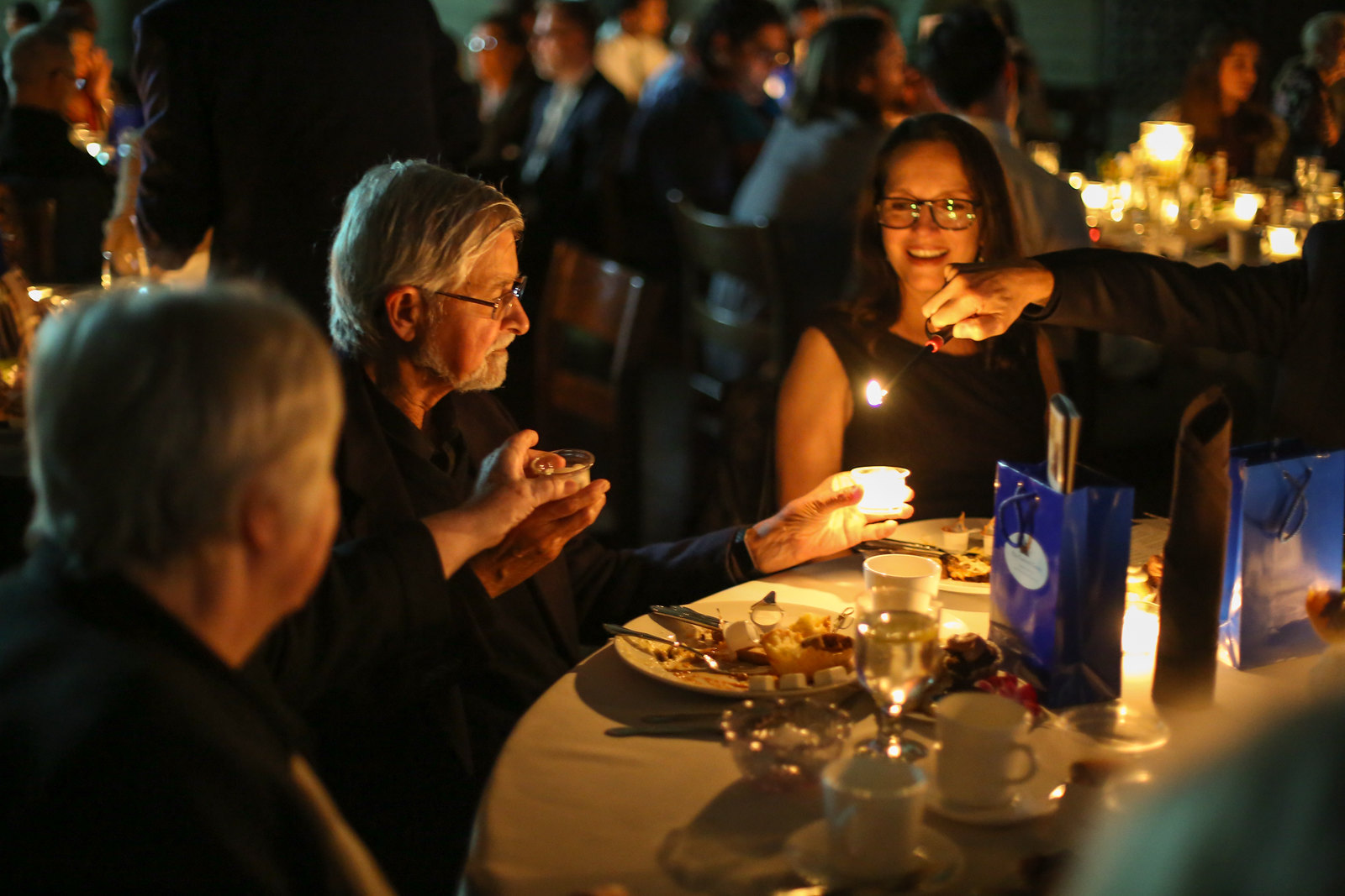 Man receiving at lit candle at the 2024 Gala