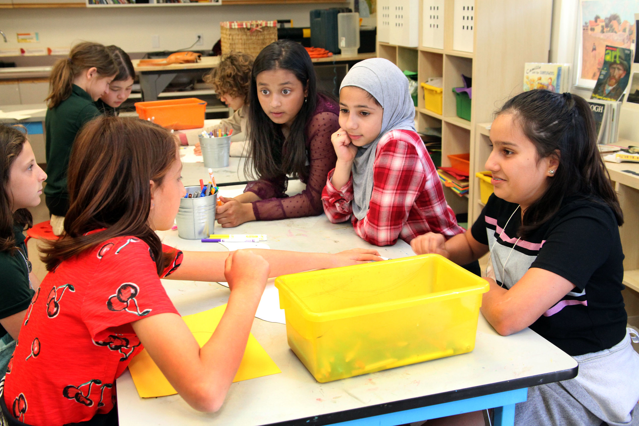 Group of children talking as they color