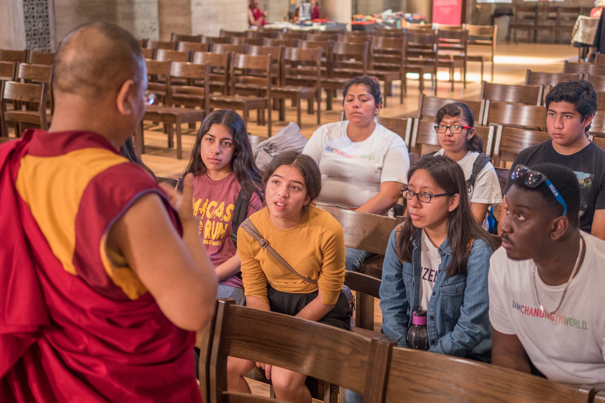 Buddhist Monk speaking to a small group of people